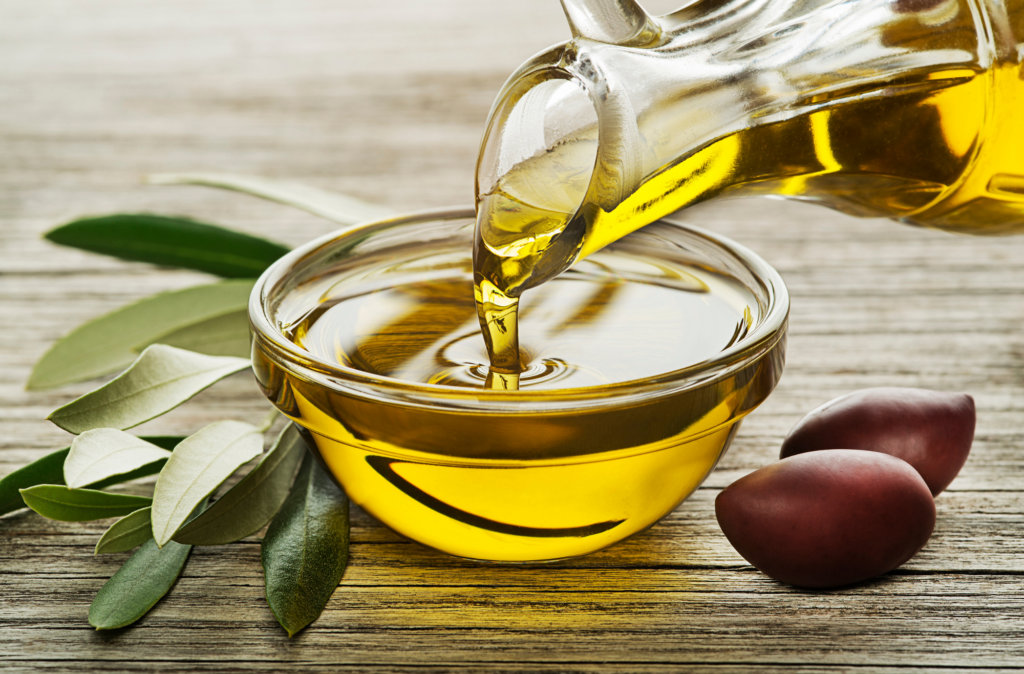 Extra Virgin Olive Oil being poured into a glass bowl